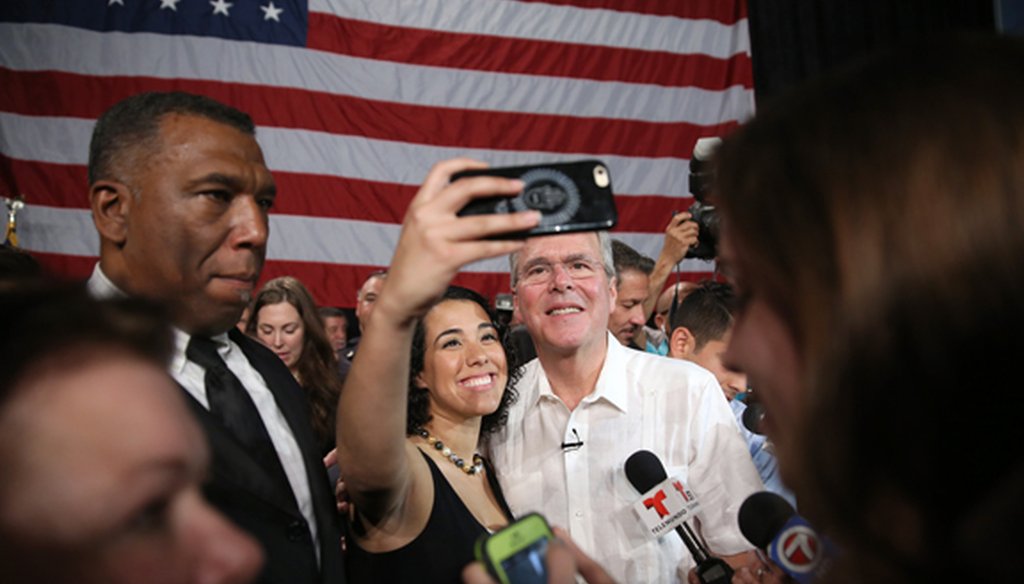 Former Gov. Jeb Bush takes a photo with a supporter at a fund-raiser in Sweetwater on May 18, 2015. (Getty Images)