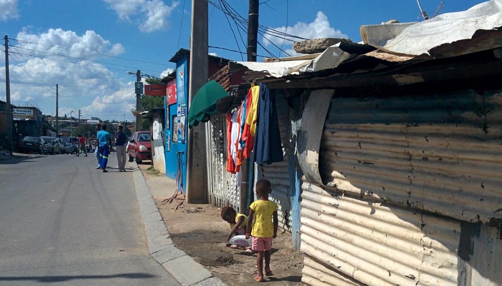 Toddlers play outside sheet metal shacks in the Alexandra township in Johannesburg, South Africa. (Jon Greenberg)