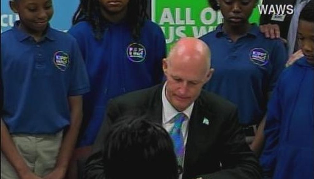 Gov. Rick Scott signs SB 736 on March 24, 2011. Photo courtesy of WPLG. 