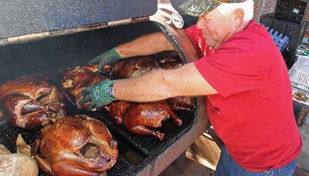 Bruce Green, an Arkansas resident, turns over big ol' turkeys in advance of a Thanksgiving Salvation Army celebration (Associated Press, Michael Orrell).