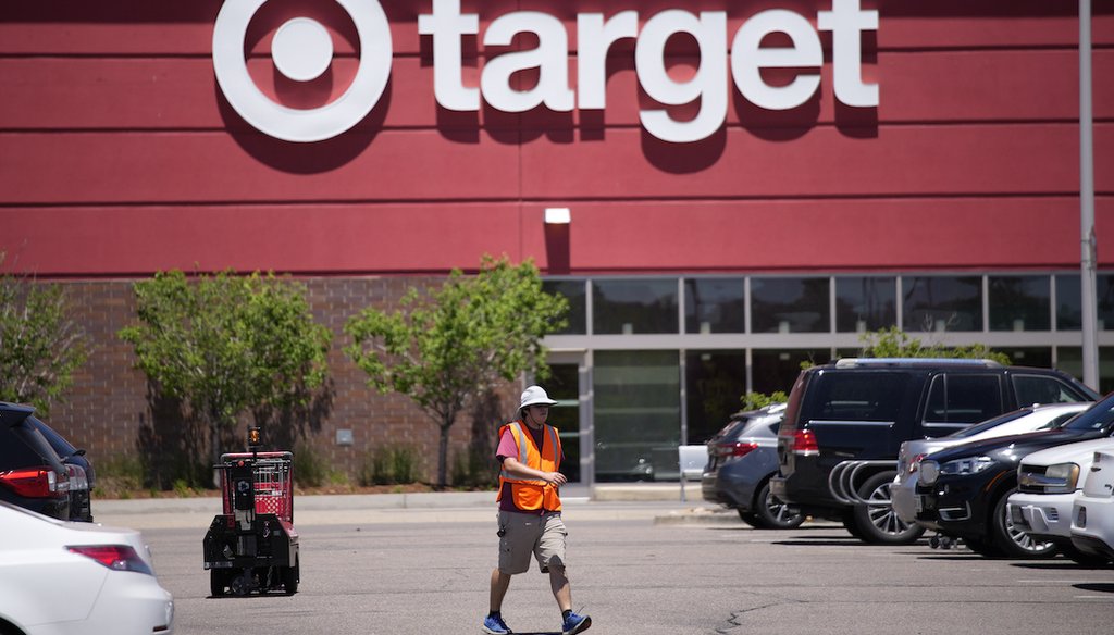 A worker collects shopping carts in the parking lot of a Target store on June 9, 2021, in Highlands Ranch, Colo. (AP)