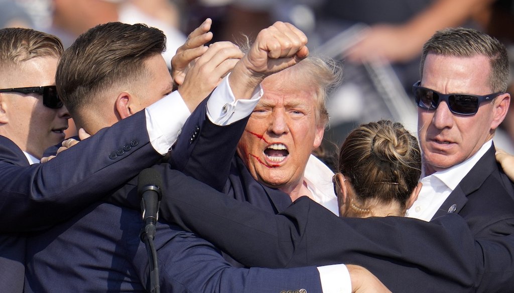 Rallygoers react after former President Donald Trump is shot at a rally July 13, 2024, in Butler, Pa. (AP)