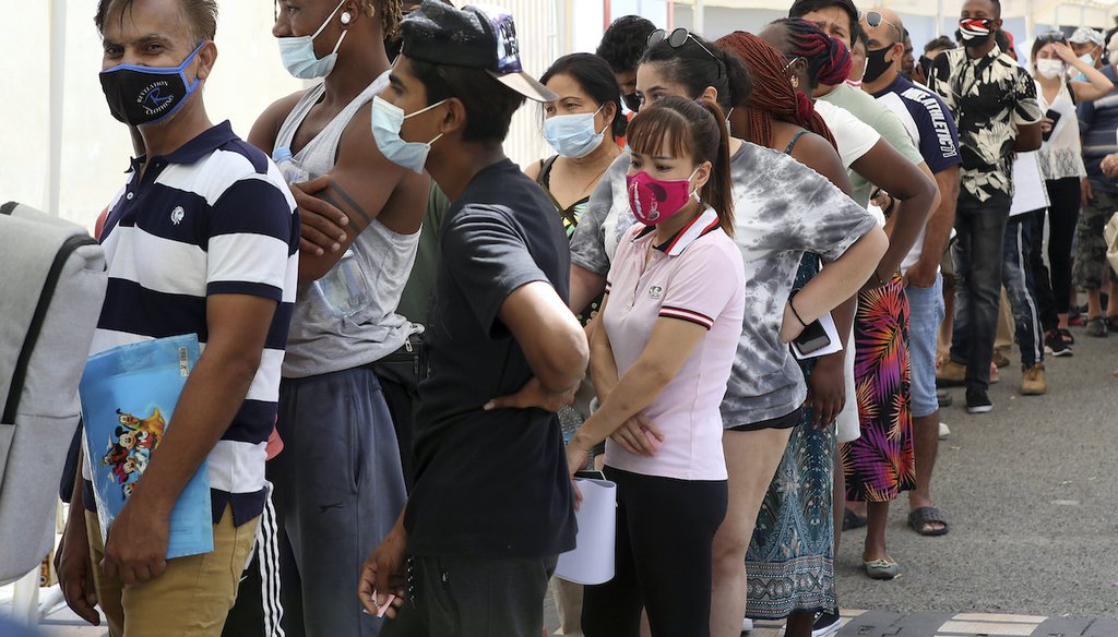 People wait in line to receive a COVID-19 vaccine shot at Cyprus' State Fair in Nicosia, Cyprus, Aug. 13, 2021. (AP)